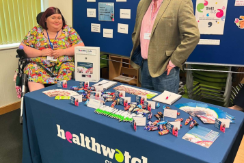 Photo of two Healthwatch Shropshire Volunteers on a stand at an engagement event
