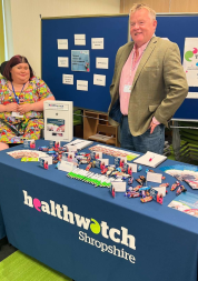 Photo of two Healthwatch Shropshire Volunteers on a stand at an engagement event