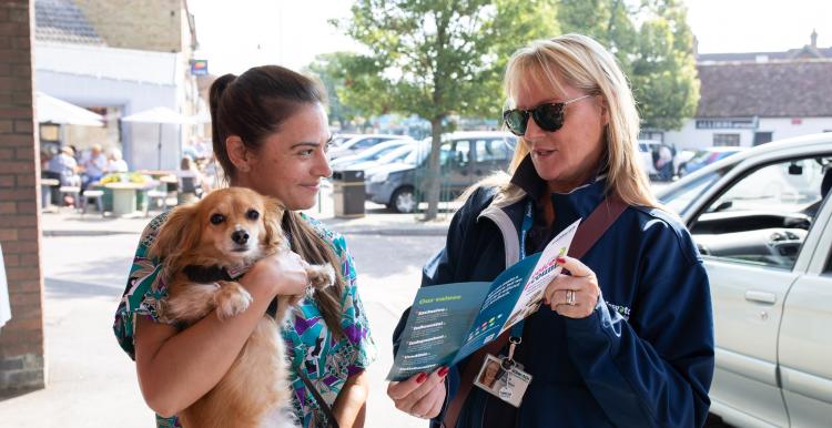 Woman with dog being asked questions