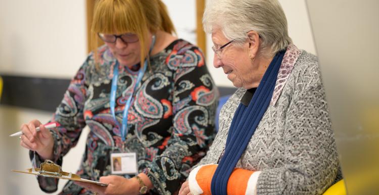 Member of staff talking to a patient