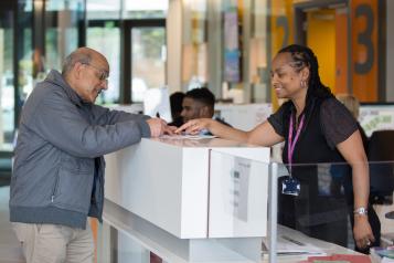 Patient speaking to a receptionist