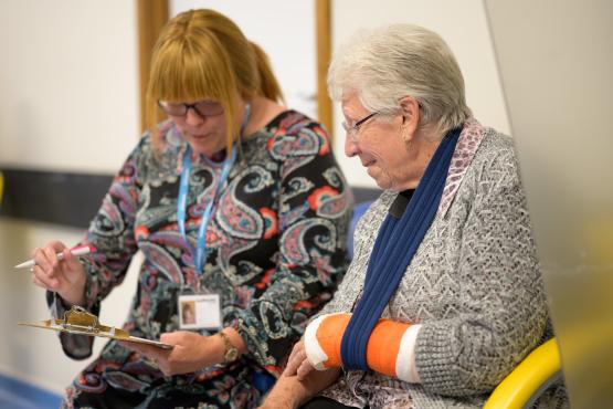 Member of staff talking to a patient